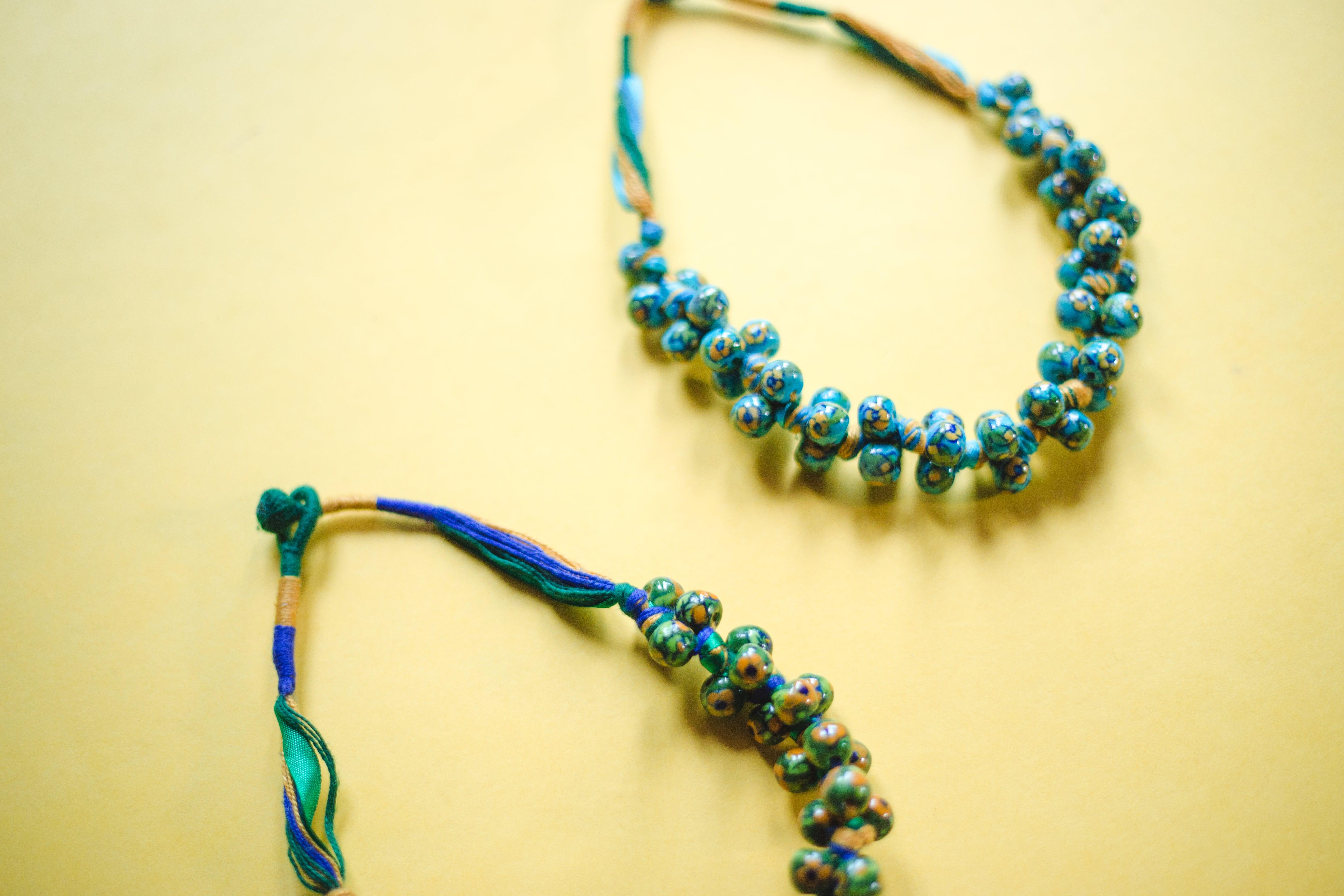 Kaisori Blue Pottery Knot necklace - green and yellow Kaisori